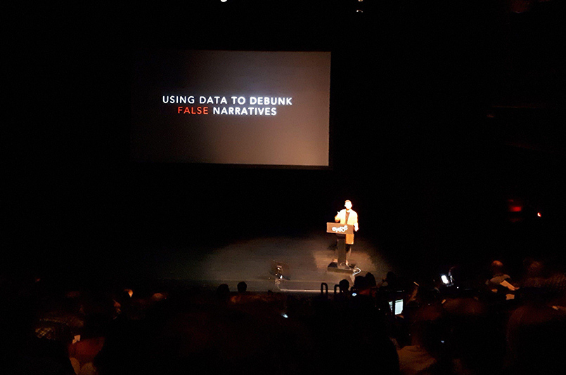 Photo of the talk by Sam Sinyangwe - the slide reads "using data to debunk false narratives"